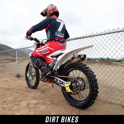 Person on a dirt bike with 'mx' branding in an outdoor setting