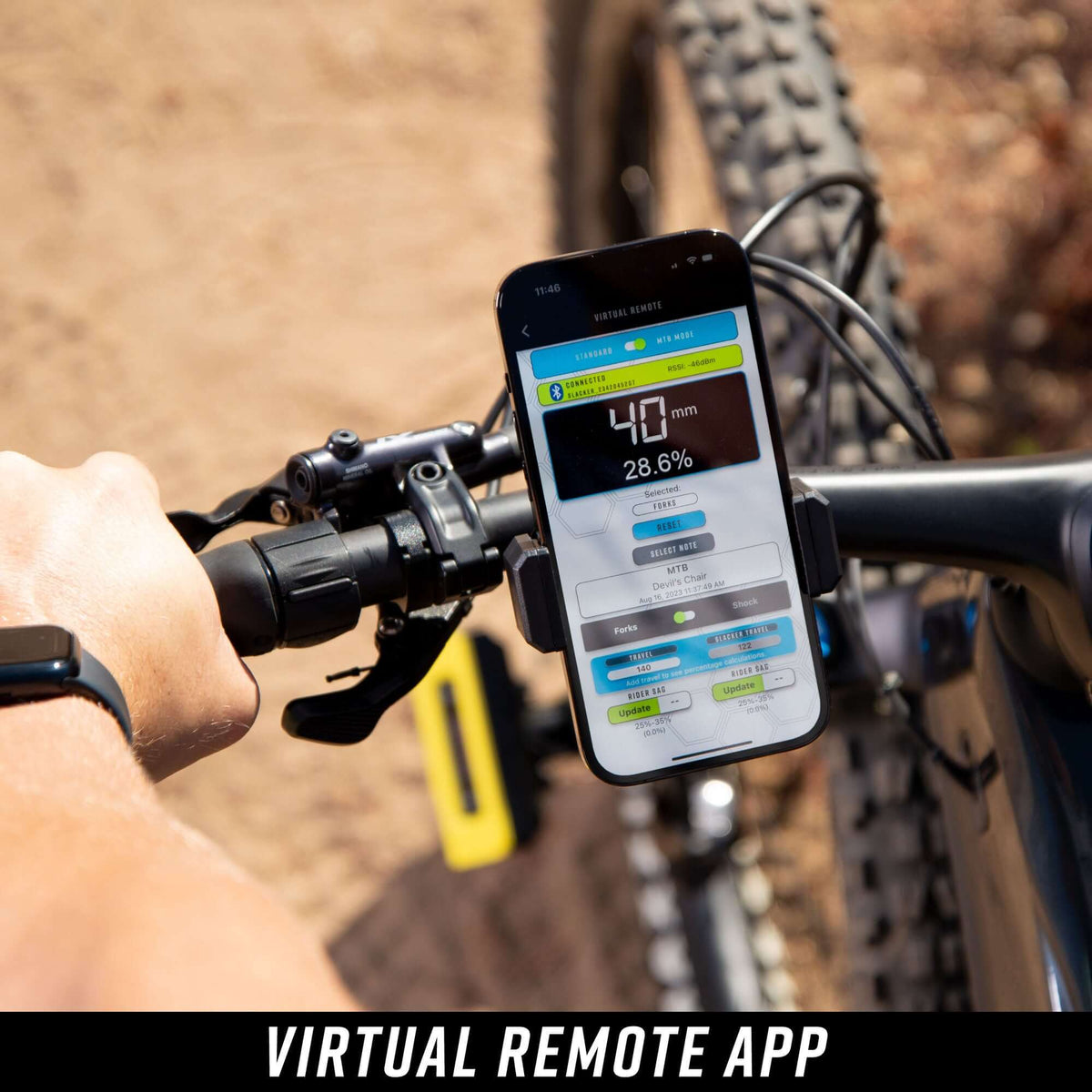Person holding a smartphone using slacker app on a bike, showing suspension setting and other metrics.